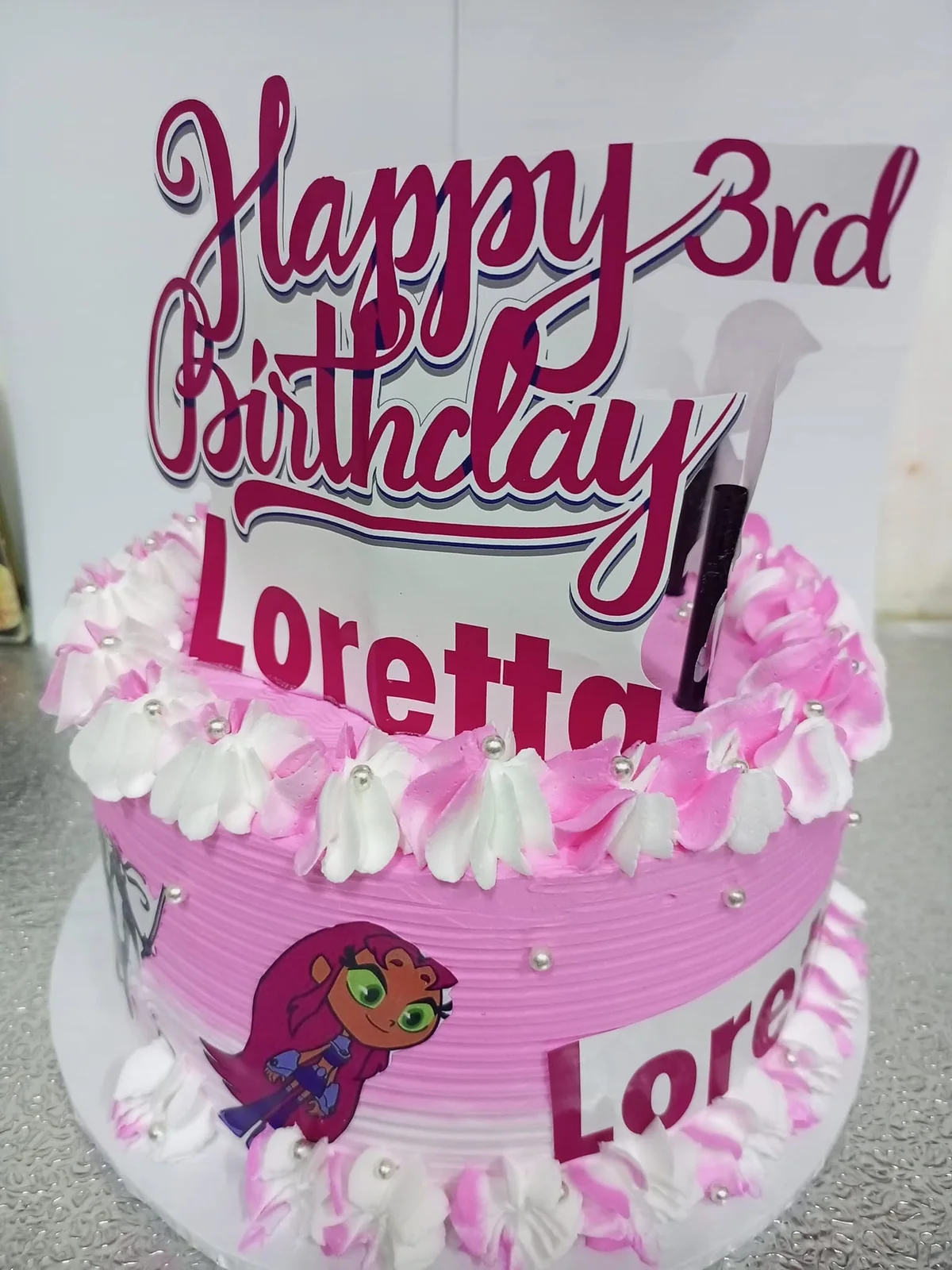 Pink third birthday character cake by Stark’s Cake House in Turkana